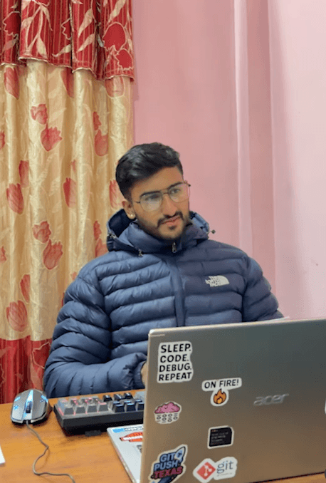 Max coding at his desk